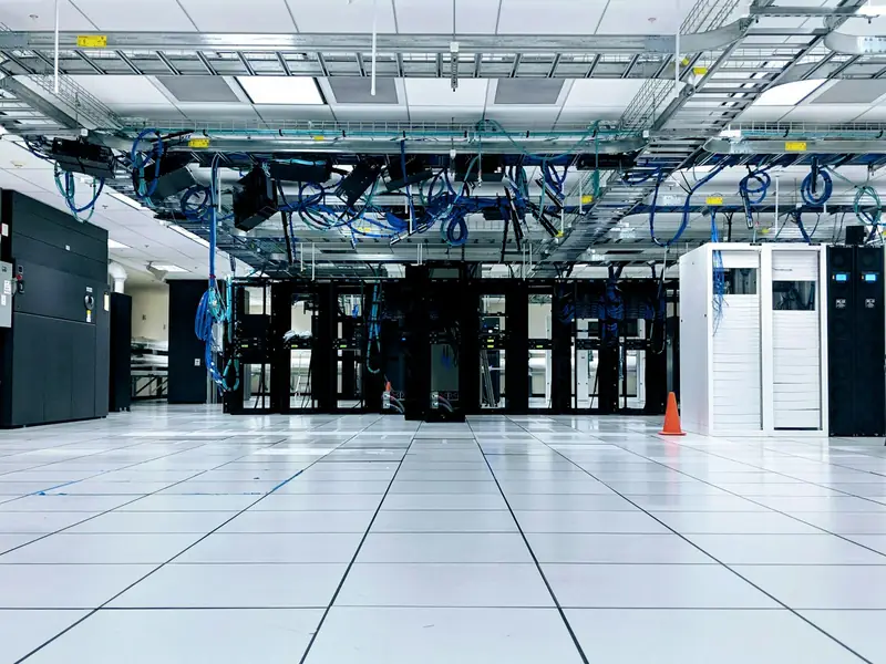 Bright, white data center with rows of server cabinets