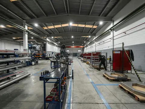 Manufacturing floor with workstations and metal stock