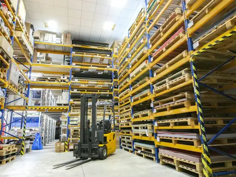 Forklift working in a warehouse aisle of pallet racking